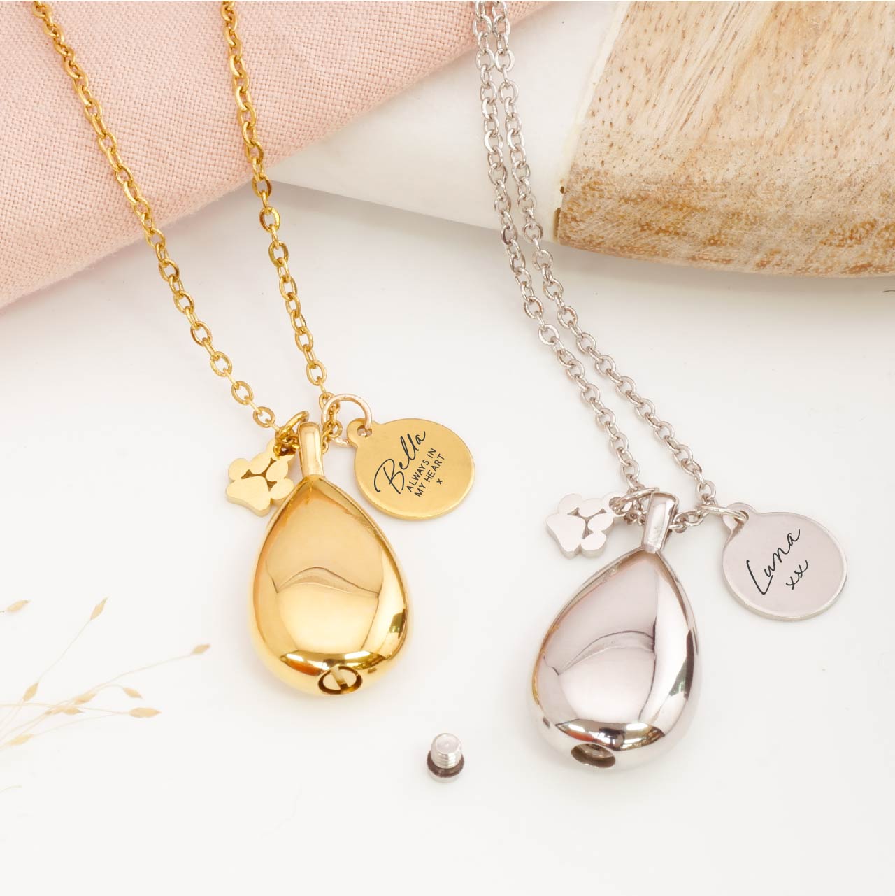 Detailed view of teardrop pet ashes pendant – showcasing engraving and paw print charm