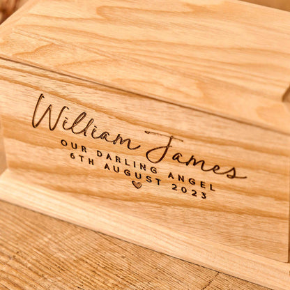 Close-up view of custom engraving on stillborn baby's wooden urn.