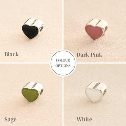 Silver Heart Cremation ashes charms colour example with black, dark pink, sage and white resin filled with ashes or fur, displayed on a soft beige background – suitable for pet or human memorials.