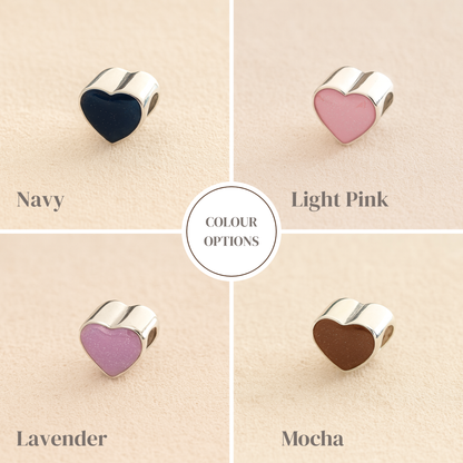 Silver Heart Cremation ashes charms colour example with navy, light pink lavender and mocha resin filled with ashes or fur, displayed on a soft beige background – suitable for pet or human memorials.