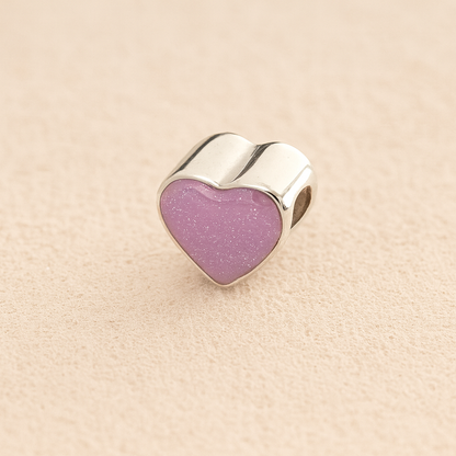 Silver Heart Cremation ashes charm with lavender resin filled with ashes or fur, displayed on a soft beige background – suitable for pet or human memorials.