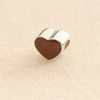 Silver Heart Cremation ashes charm with mocha resin filled with ashes or fur, displayed on a soft beige background – suitable for pet or human memorials.