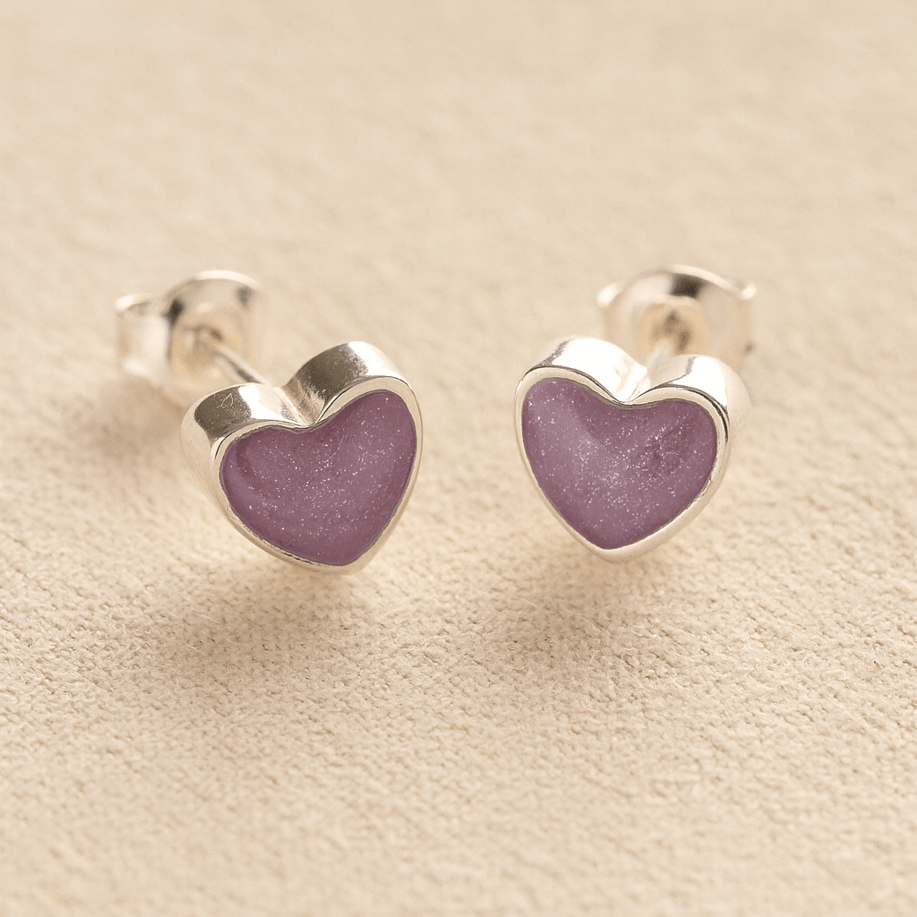 Heart-shaped memorial earrings studs with lavender resin with cremation ashes or fur a beige fabric background