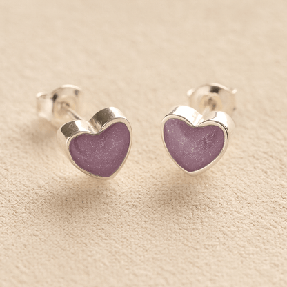Heart-shaped memorial earrings studs with lavender resin with cremation ashes or fur a beige fabric background