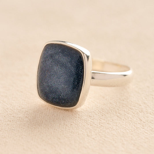 Silver Square Memorial Ashes Cremation Ring with Navy resin, filled with ashes or fur, displayed on a soft beige background – suitable for pet or human memorials.