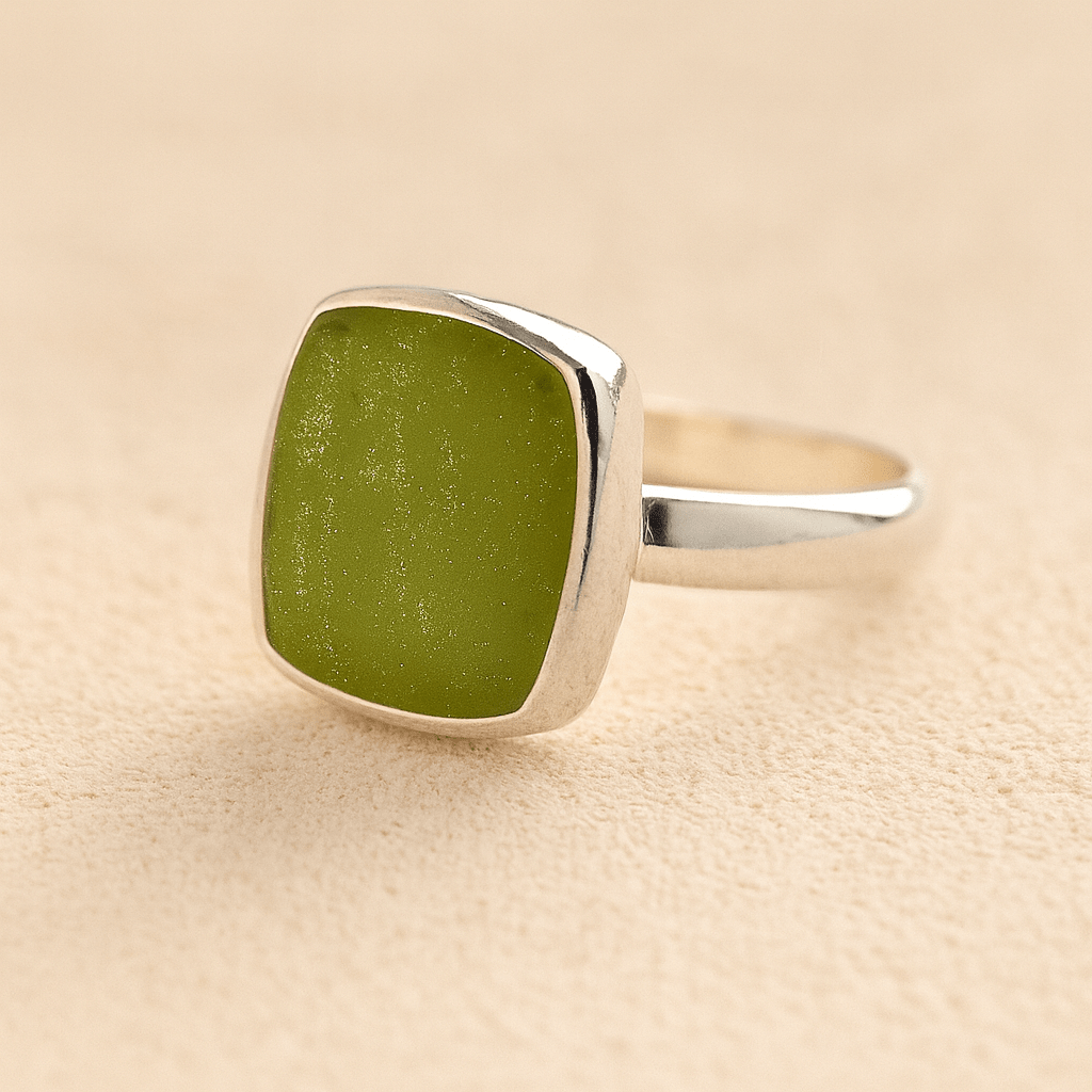 Silver Square Memorial Ashes Cremation Ring with sage resin, filled with ashes or fur, displayed on a soft beige background – suitable for pet or human memorials.