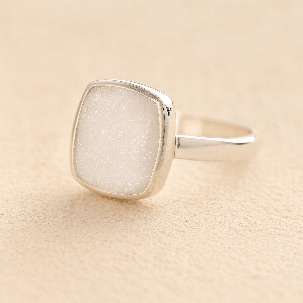 Silver Square Memorial Ashes Cremation Ring with white resin, filled with ashes or fur, displayed on a soft beige background – suitable for pet or human memorials.