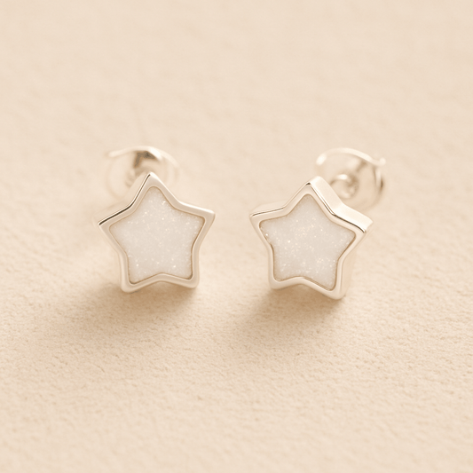 Silver Memorial Star Ashes Earrings with white resin on a beige background