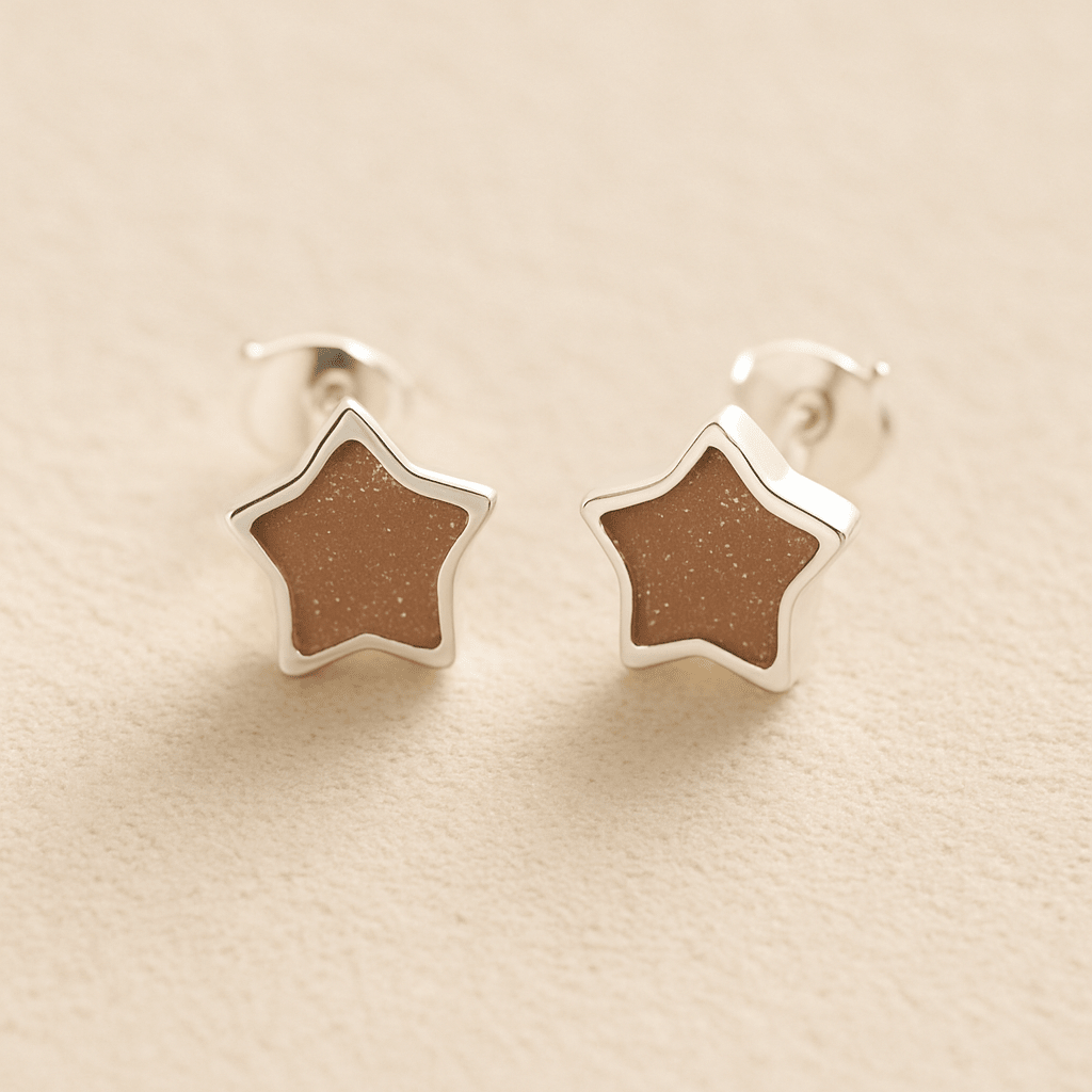 Silver Memorial Star-Shaped Ashes Earrings with mocha resin on a beige background
