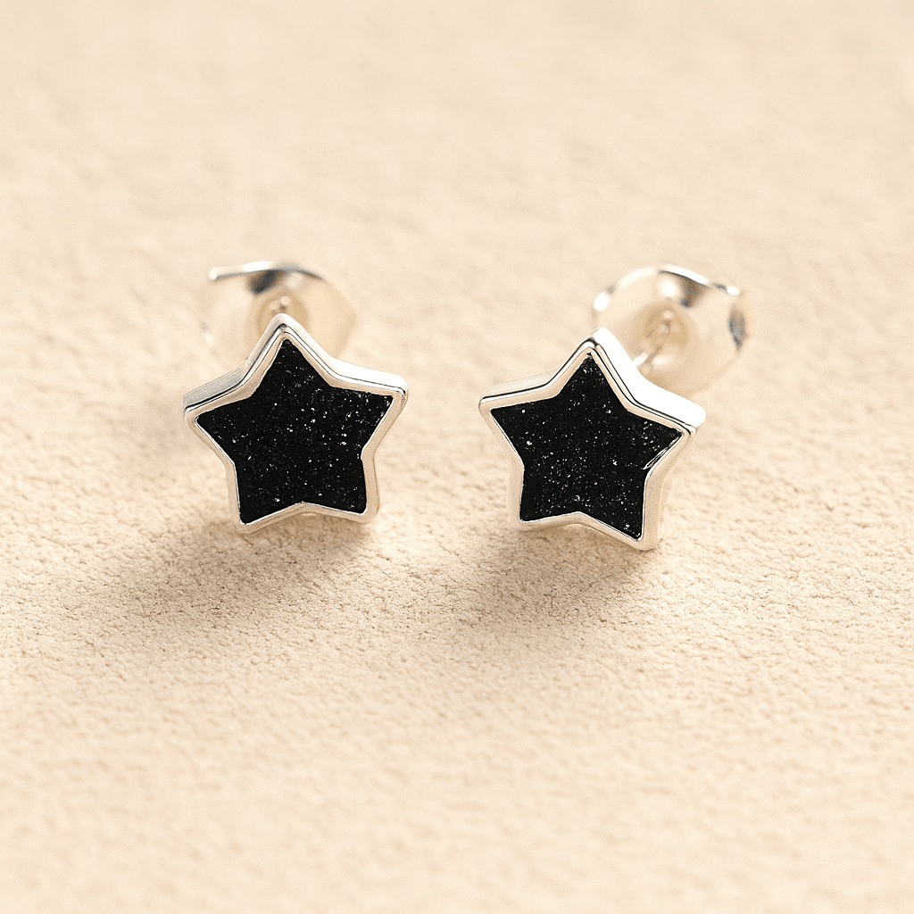 Silver Memorial Star-Shaped Ashes Earrings with black resin on a beige background