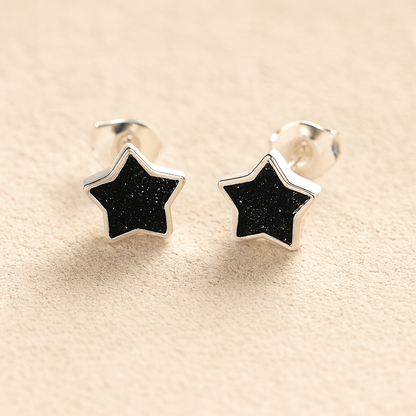 Silver Memorial Star-Shaped Ashes Earrings with black resin on a beige background