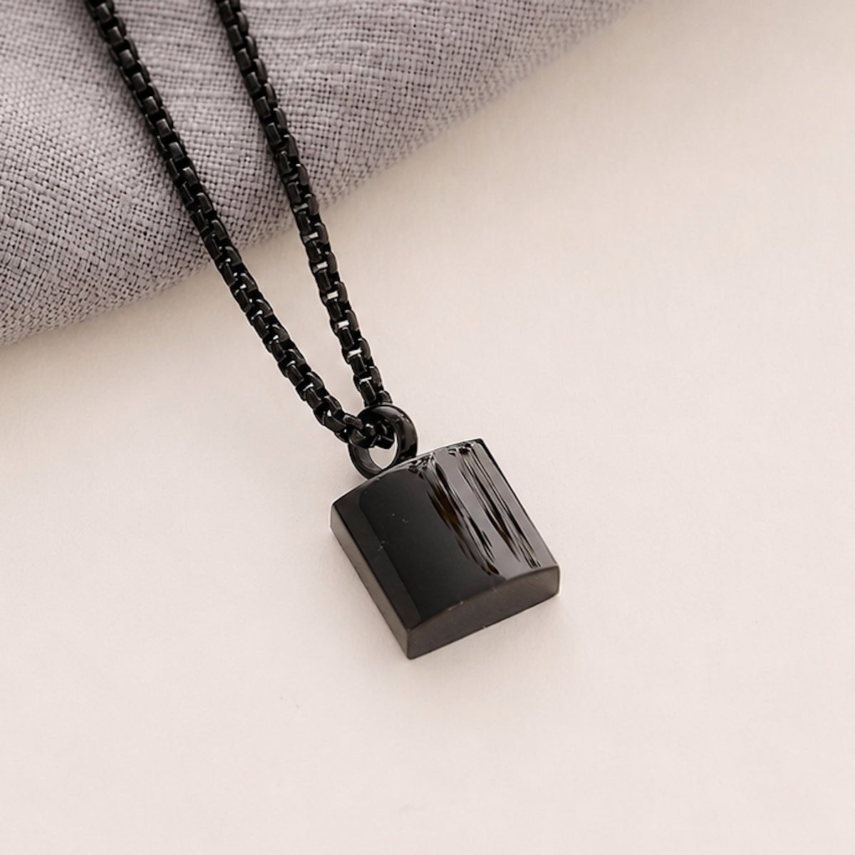 Black Men’s Square memorial Pendant on a beige background 