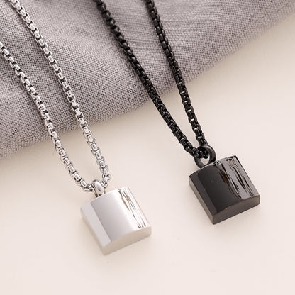 Silver and black Men’s Square memorial Pendant on a beige background 