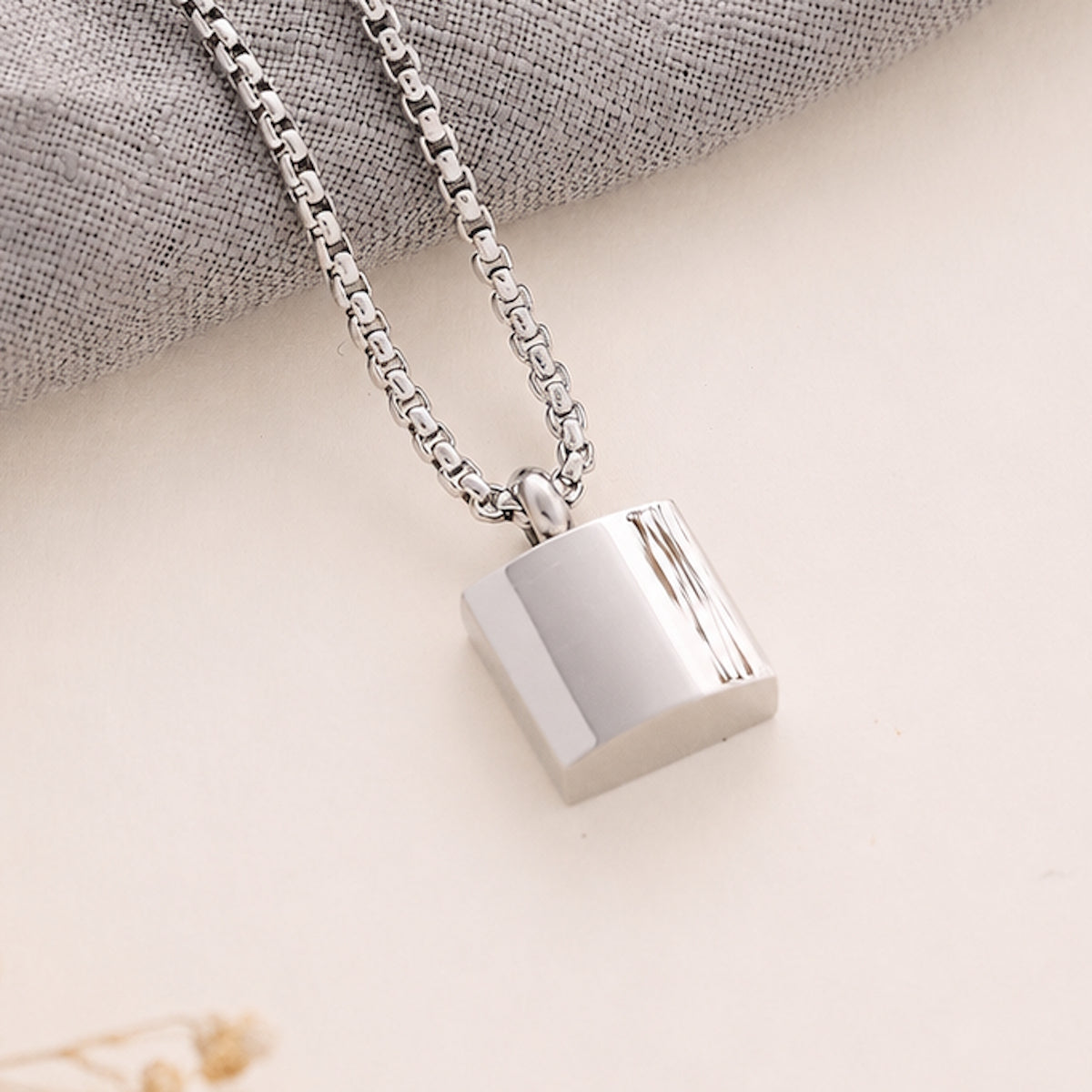 Silver Men’s Square memorial Pendant on a beige background 