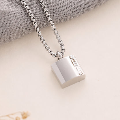 Silver Men’s Square memorial Pendant on a beige background 