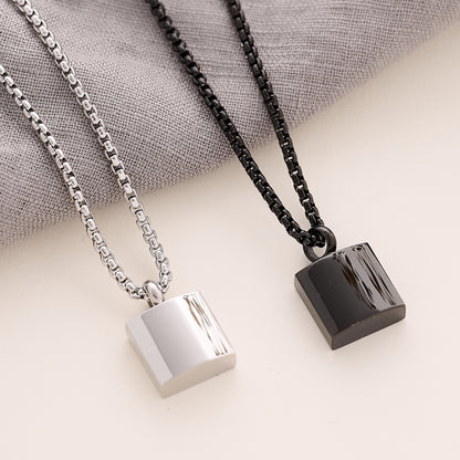 Silver and black Men’s Square memorial Pendant on a beige background 