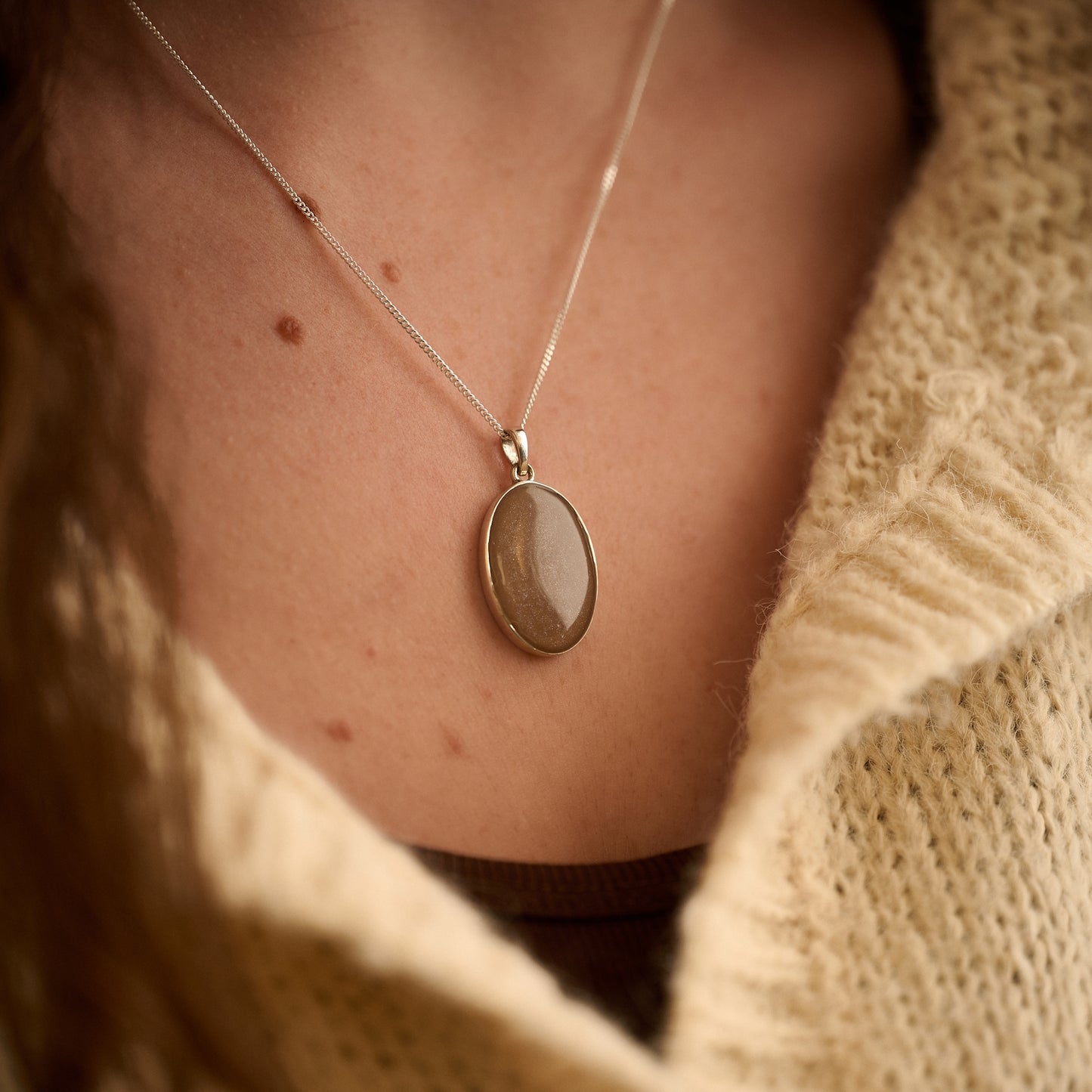Memorial ashes necklace in mocha resin worn by female model