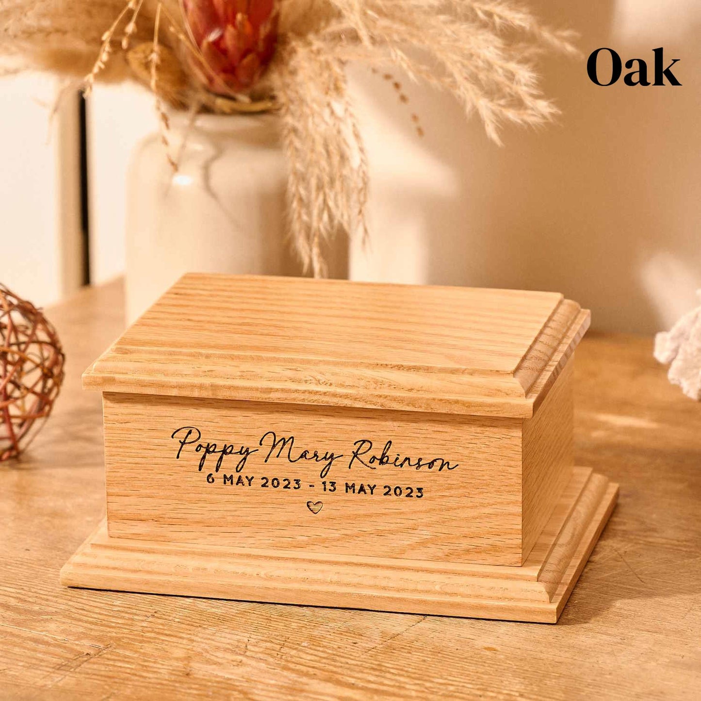 Oak wood cremation urn for stillborn baby with custom engraving.