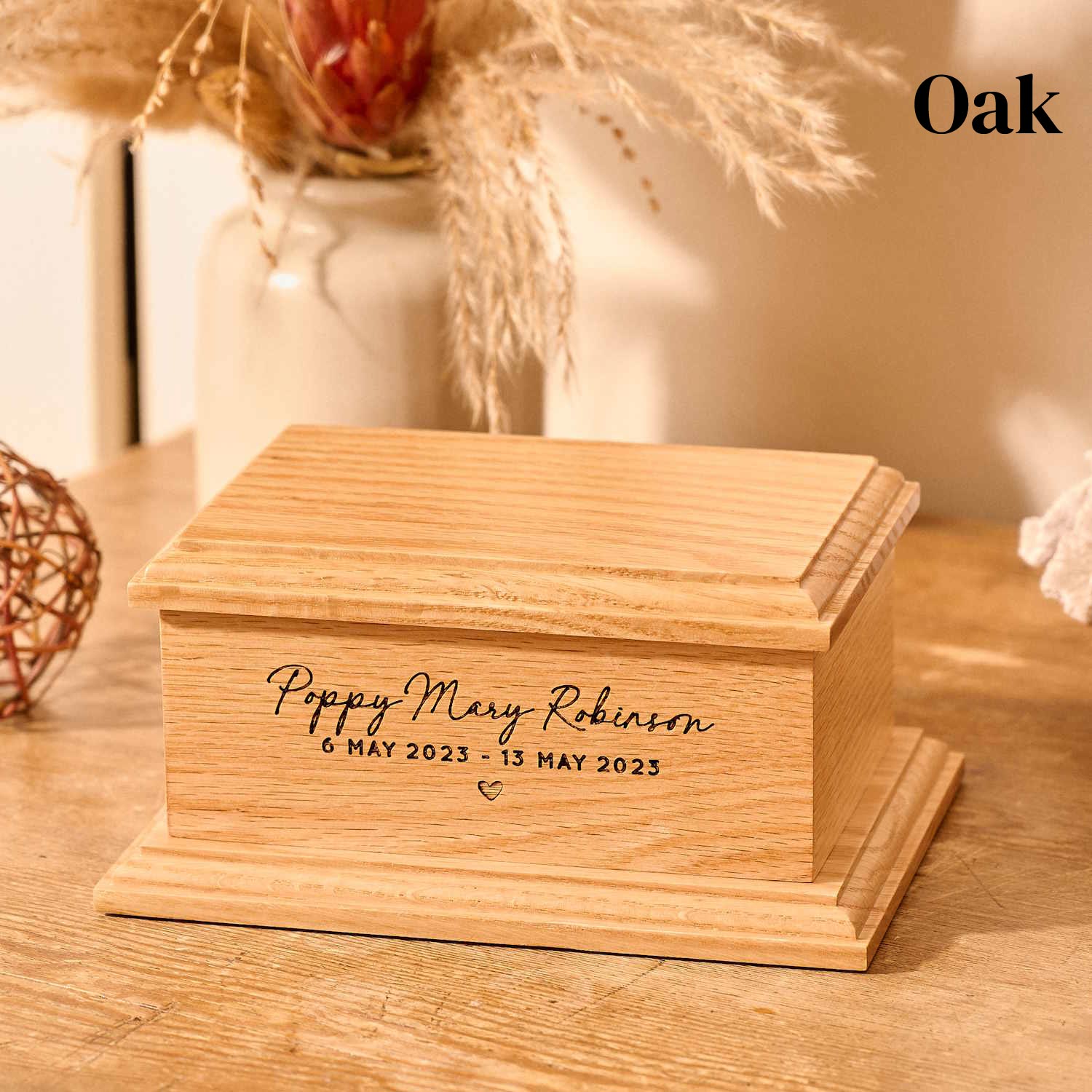 Oak wood cremation urn for stillborn baby with custom engraving.