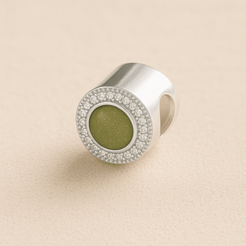 Silver Circle CZ Ashes Charm with Sage resin on a beige background