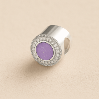 Silver Memorial Ashes Circle CZ Cremation Charm with lavender resin on a beige background