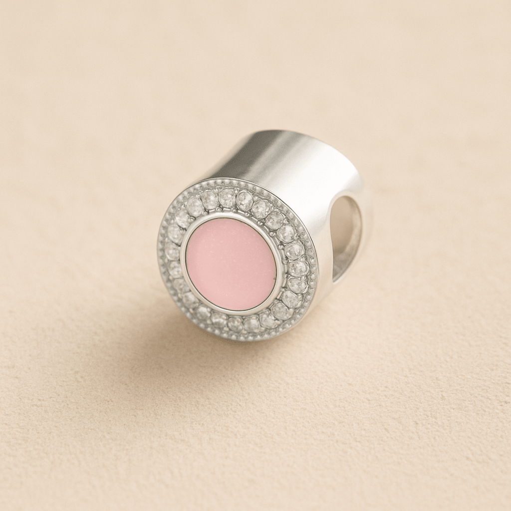 Silver Circle CZ Ashes Cremation Charm with Light Pink resin on a beige background