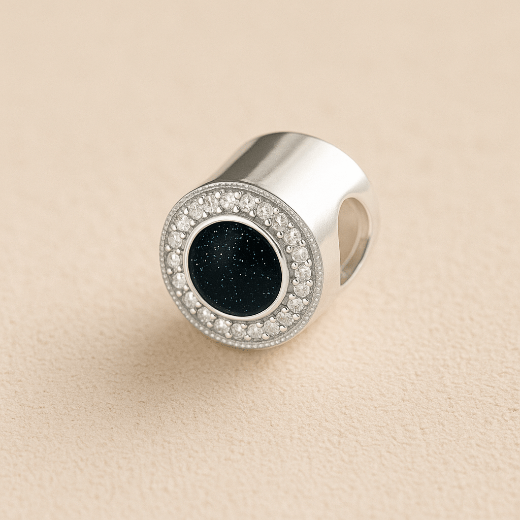 Silver Circle CZ Ashes Cremation Charm with Black resin on a beige background