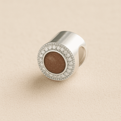 Silver Circle CZ Ashes Cremation Charm with Mocha resin on a beige background