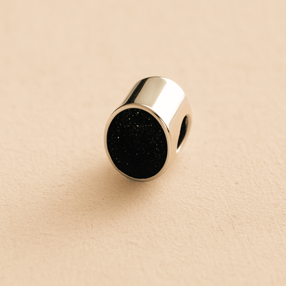 Silver Oval memorial ashes bead with a black resin infill designed to hold cremation ashes and pet fur. Memorial keepsake for pet loss