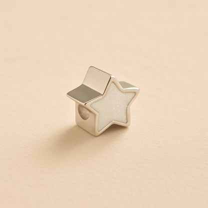 Silver Memorial Star Charm Bead with white resin on a beige background