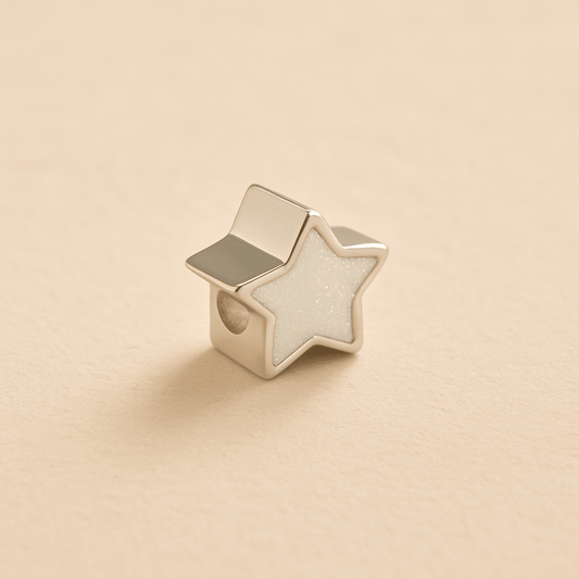 Silver Memorial Star Charm Bead with white resin on a beige background