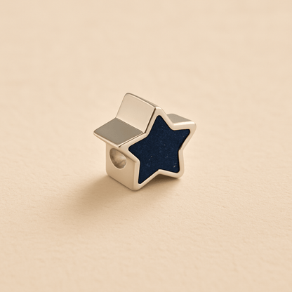 Silver Memorial Star Charm Bead with navy resin on a beige background