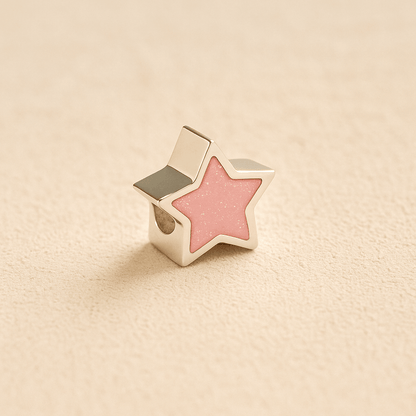Silver star-shaped Memorial Charm Bead with light pink resin on a beige background