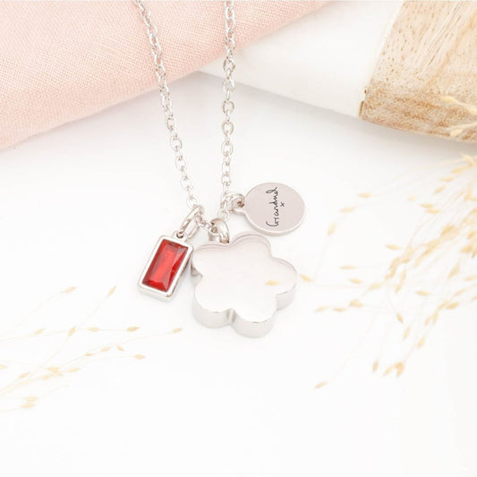 Silver handwriting jewellery, flower urn necklace and birthstone charm on a light background
