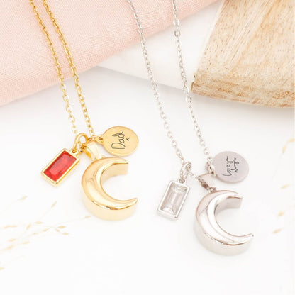 memorial necklace with handwriting engraving on a table.