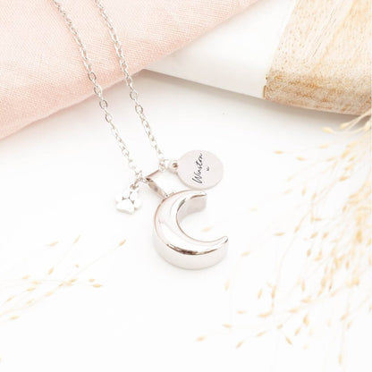 Silver pet memorial necklace in a moon shape, engraved tag and paw print charm 