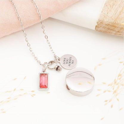 Close-up of circular cremation pendant – detailed view of memorial jewellery for stillborn loss or Mother's Day remembrance