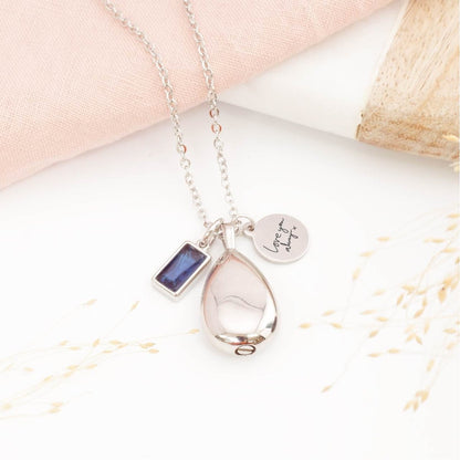 Handwriting necklace, with teardrop shape memorial pendant and birthstone charm on a light background. Memorial necklaces UK 