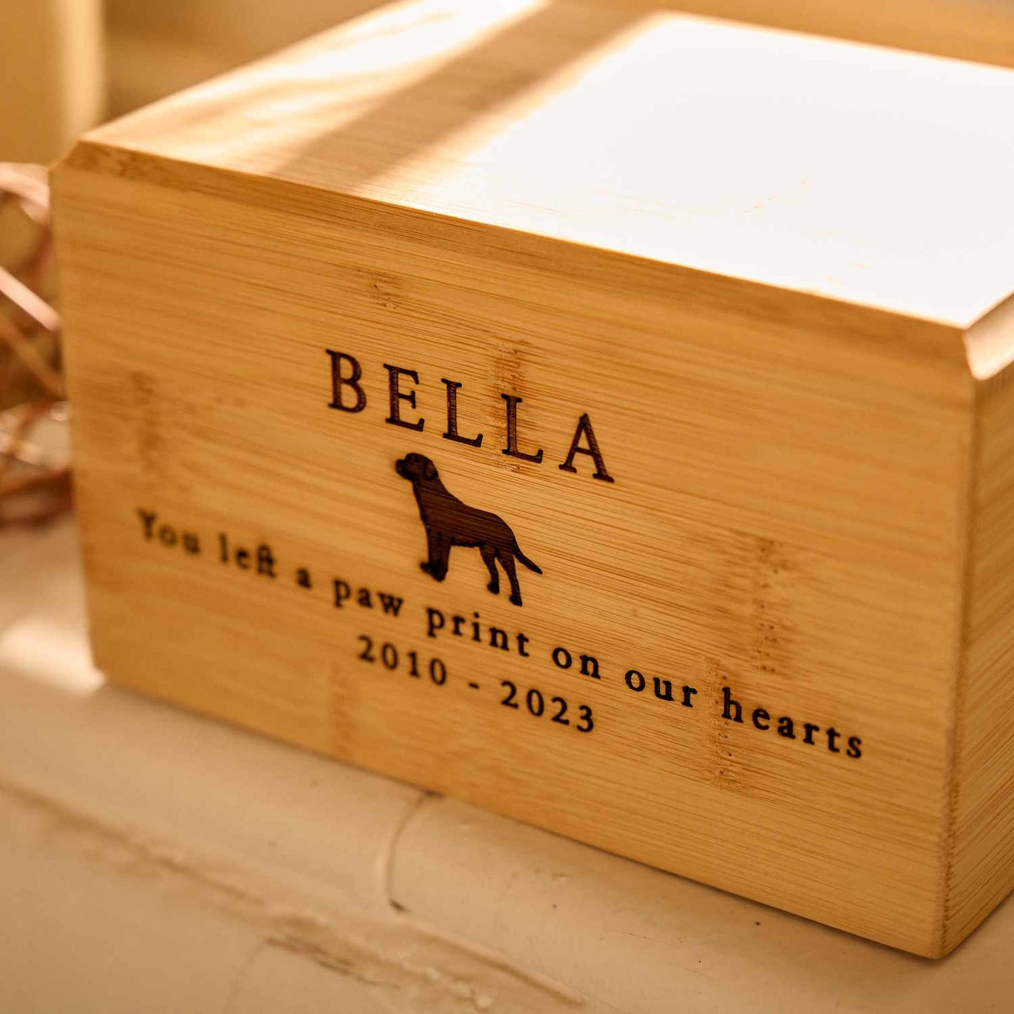 Close-up of bamboo wood pet cremation urn – eco-friendly engraved pet ashes keepsake