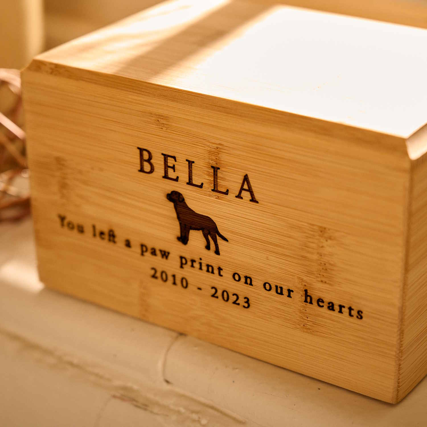 Close-up of bamboo wood pet cremation urn – eco-friendly engraved pet ashes keepsake