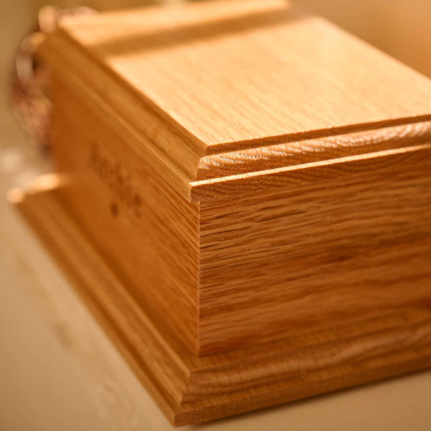Close-up of custom engraving on pet cremation urn.