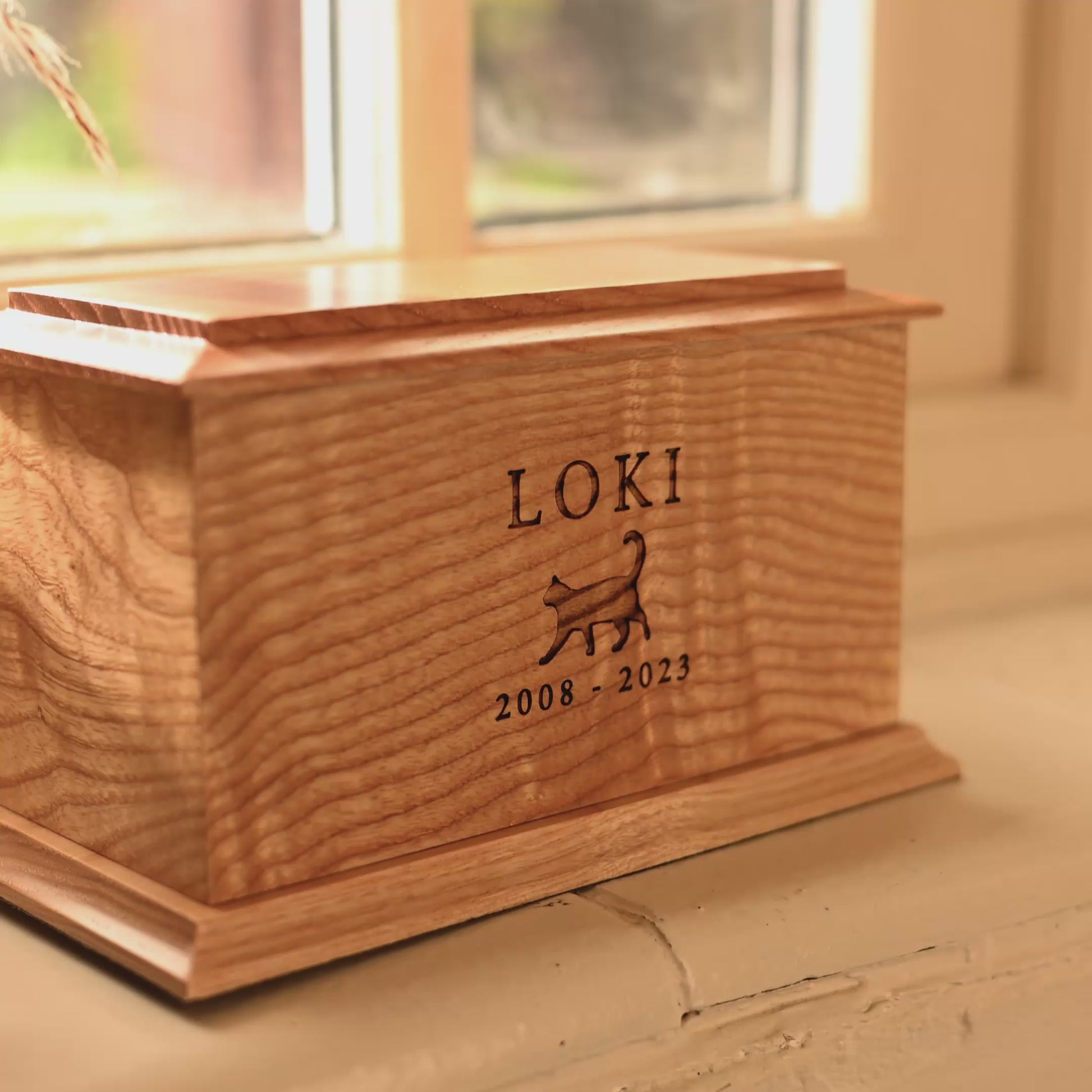 A video showing details of a cat urn. It is a cremation urn for cats with the name Loki engraved above an engraved cat. The urn is for pet ashes.