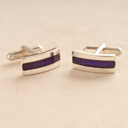 Silver Curved Ashes cufflinks with purple resin inlay with cremation ashes or fur on a beige background