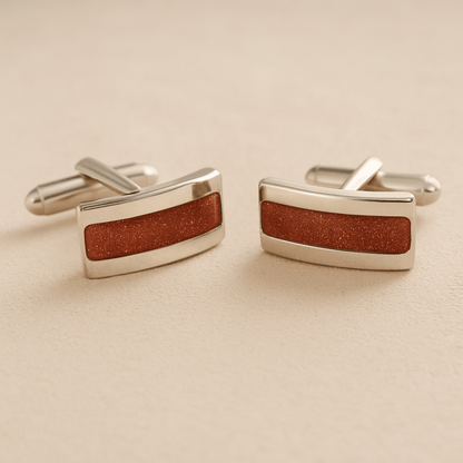 Silver Curved cremation cufflinks with rust colour resin inlay with cremation ashes or fur on a beige background