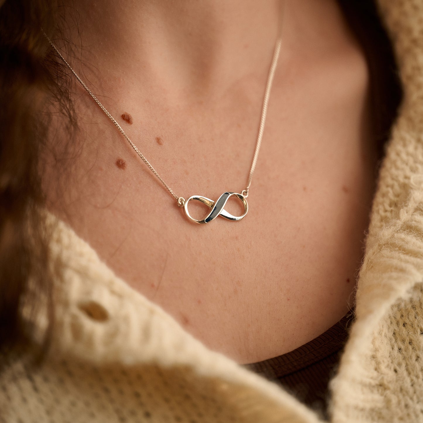 Model wearing sterling silver infinity cremation necklace