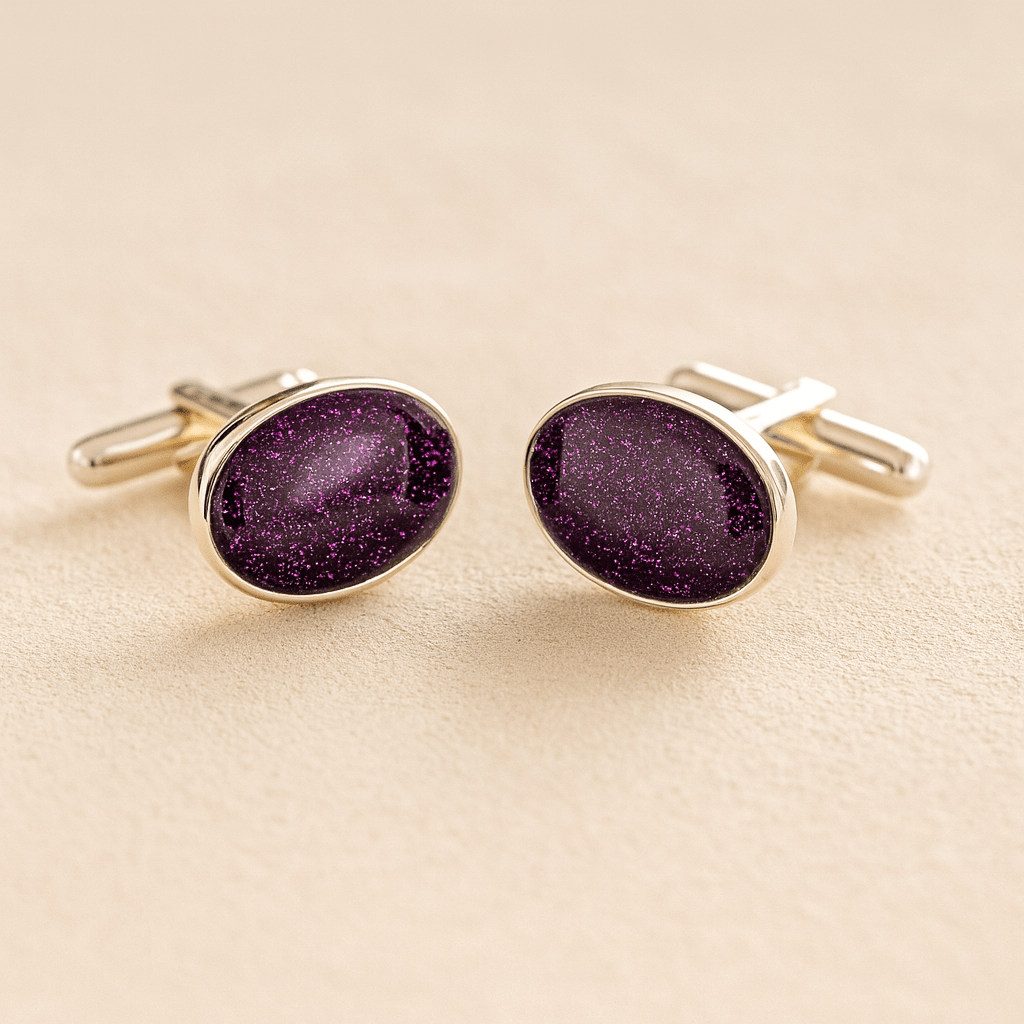 Silver oval cremation ashes cufflinks with a purple resin infill made with ashes or fur on a beige background