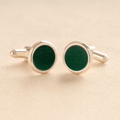 Silver Round Ashes Cufflinks with dark green resin with ashes or fur on a beige background