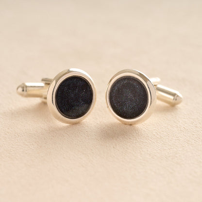 Silver Memorial Ashes Cufflinks with black resin with ashes or fur on a beige background