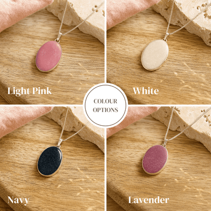 Four memorial ashes necklaces in different colors displayed on a wooden surface.