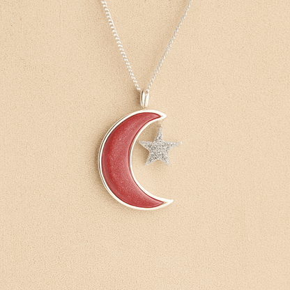Moon and Star Ashes Necklace with dark pink resin filled with ashes or fur on a beige textured background